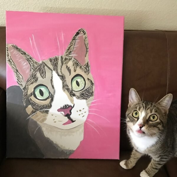 un gato acostado a un lienzo adonde se ve una pintura del mismo gato.